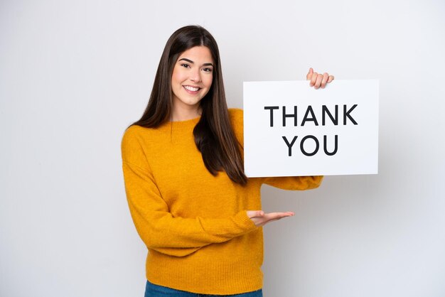 young-brazilian-woman-isolated-white-background-holding-placard-with-text-thank-you-pointing-it_1368-384128